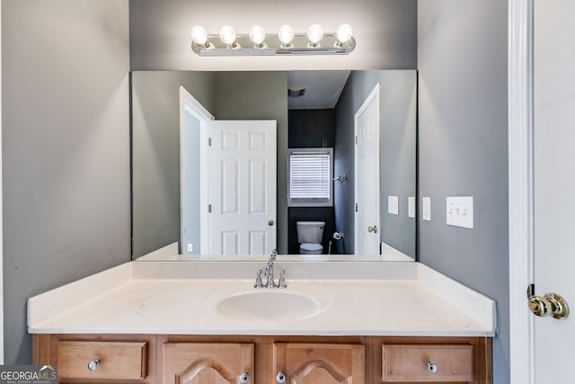 bathroom with vanity and toilet