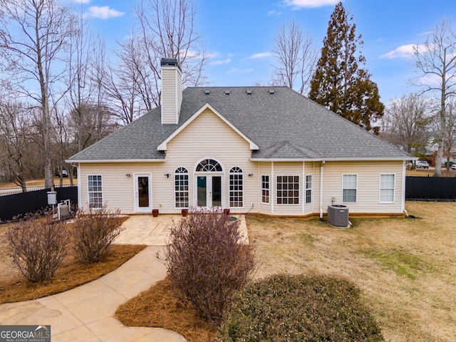 back of property featuring french doors, a yard, central AC unit, and a patio area