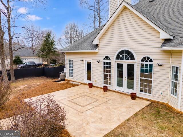 rear view of house with a patio area and french doors