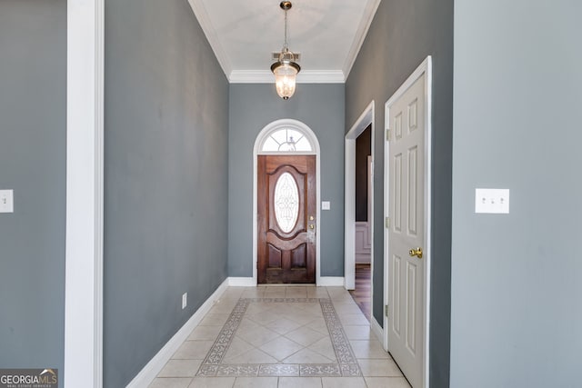foyer with ornamental molding and light tile patterned floors