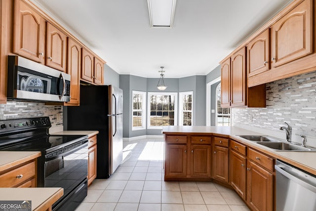 kitchen with sink, hanging light fixtures, light tile patterned floors, ornamental molding, and stainless steel appliances