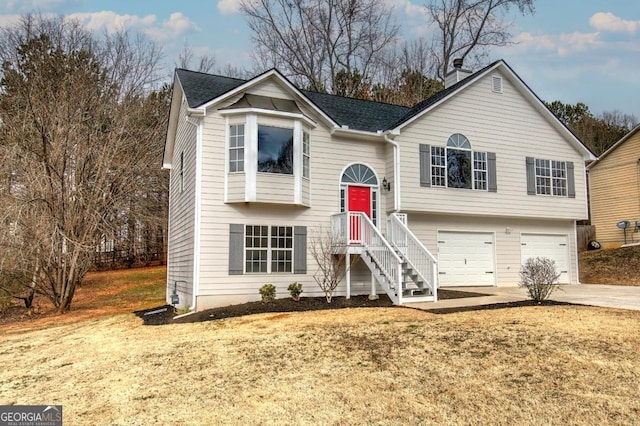 bi-level home with a garage and a front yard