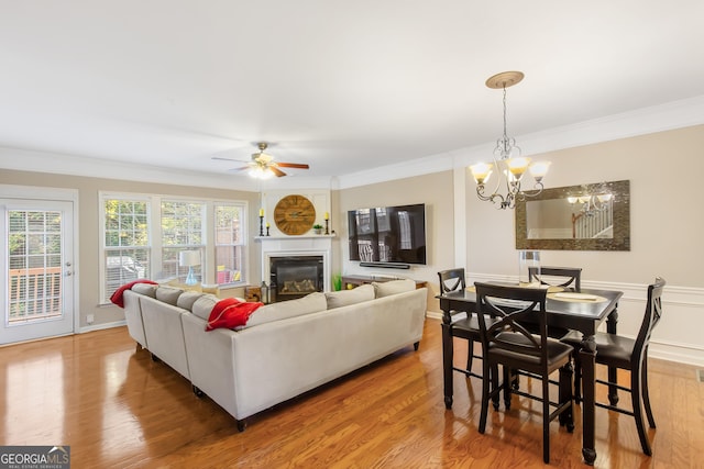 living room featuring crown molding, plenty of natural light, and wood-type flooring