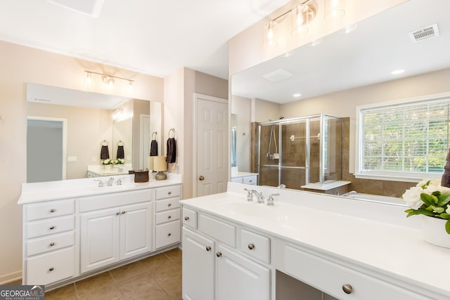 bathroom with vanity, tile patterned floors, and a shower with door