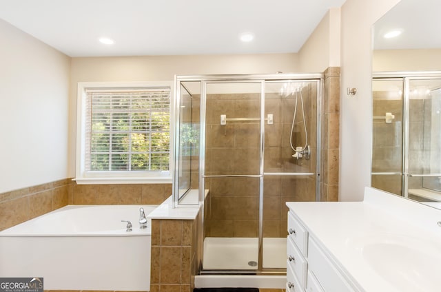 bathroom featuring vanity and independent shower and bath