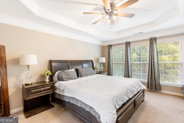 bedroom featuring crown molding, ceiling fan, a raised ceiling, and light carpet