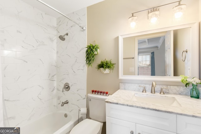 full bathroom with vanity, tiled shower / bath combo, and toilet