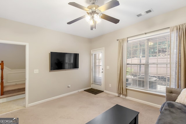 living room with light carpet and ceiling fan