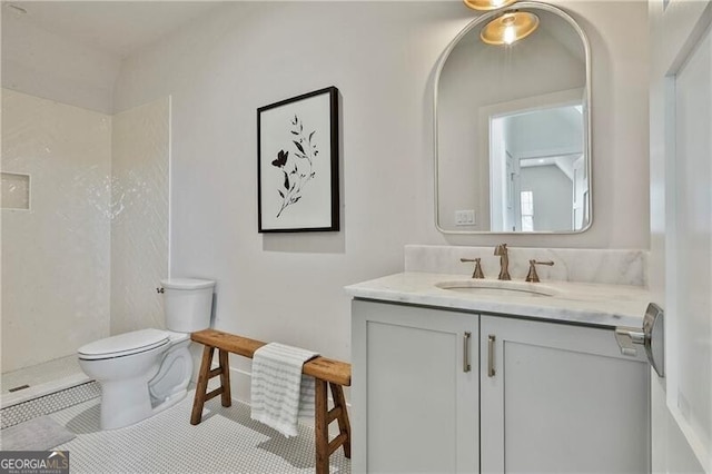 bathroom with walk in shower, vanity, and toilet