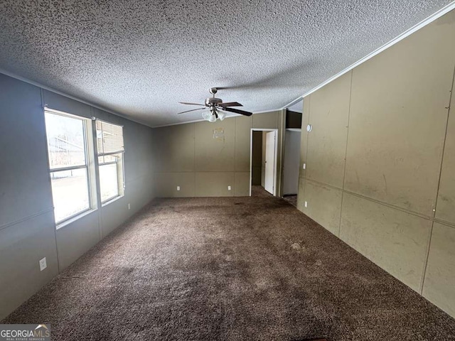 empty room featuring ceiling fan, ornamental molding, carpet flooring, and a textured ceiling