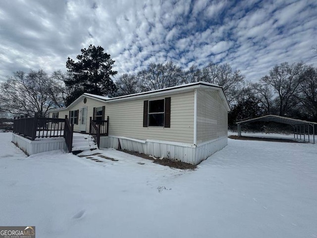 view of front of house featuring a wooden deck and a carport