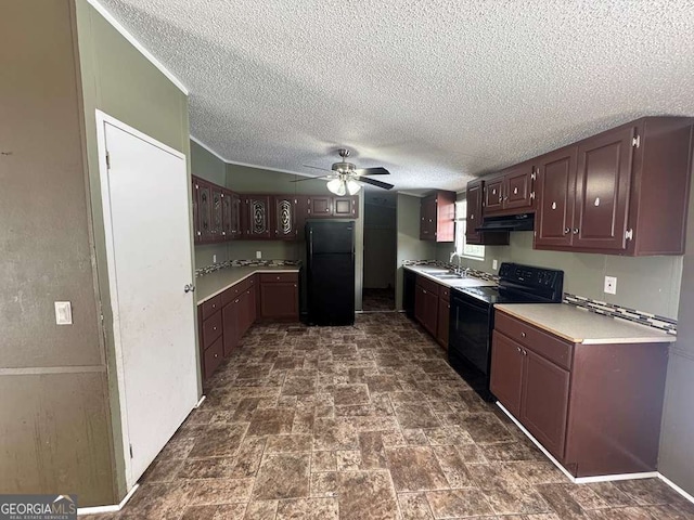 kitchen featuring light countertops, a sink, ceiling fan, under cabinet range hood, and black appliances