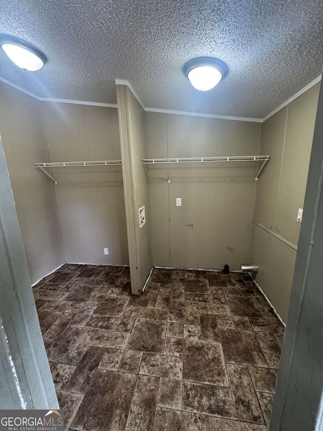 washroom with hookup for a washing machine, crown molding, and a textured ceiling