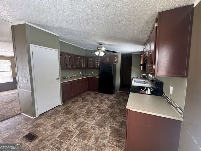 kitchen with black refrigerator, sink, ceiling fan, dark brown cabinetry, and a textured ceiling