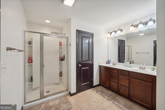 bathroom with an enclosed shower, vanity, and tile patterned flooring