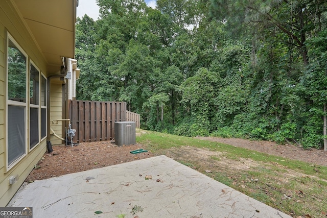 view of yard with central AC unit and a patio area