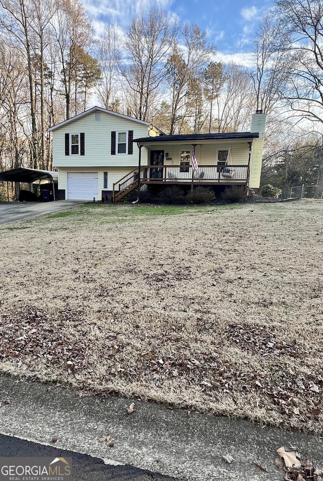 tri-level home with a porch and a garage