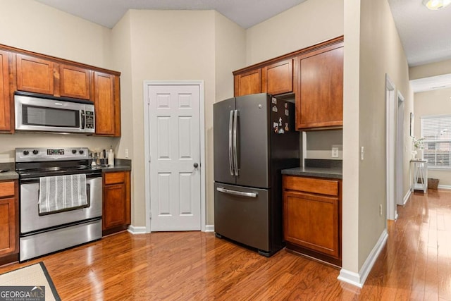 kitchen featuring hardwood / wood-style flooring and appliances with stainless steel finishes