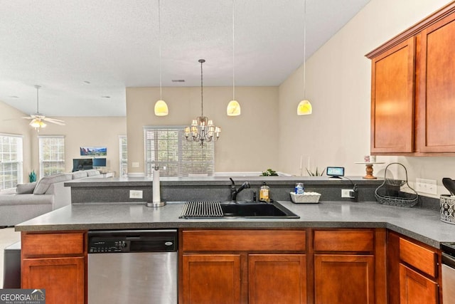 kitchen with hanging light fixtures, dishwasher, sink, and a textured ceiling