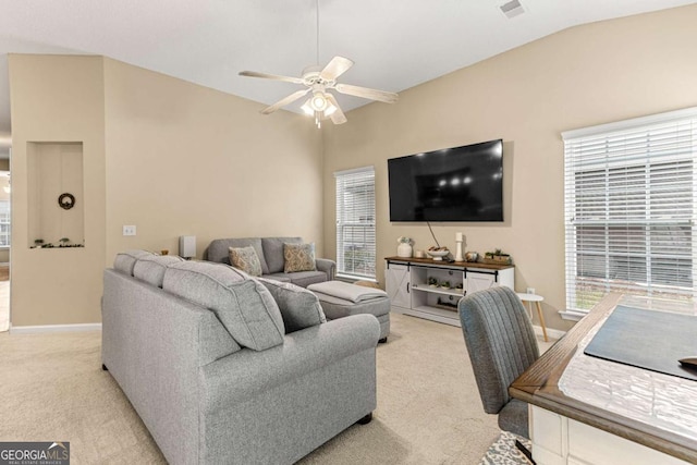 carpeted living room featuring plenty of natural light, ceiling fan, and vaulted ceiling