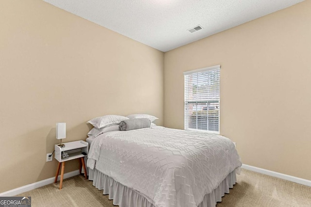 carpeted bedroom with a textured ceiling