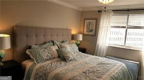 bedroom with ornamental molding