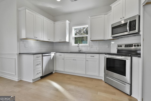 kitchen with white cabinetry and stainless steel appliances