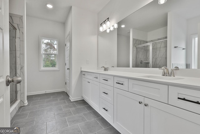 bathroom with vanity and a shower with shower door