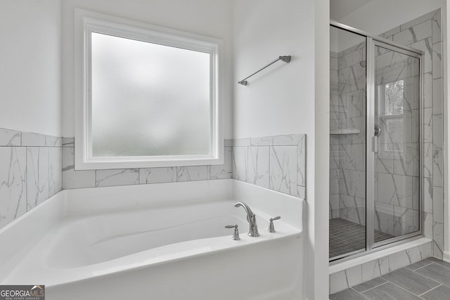 bathroom featuring separate shower and tub