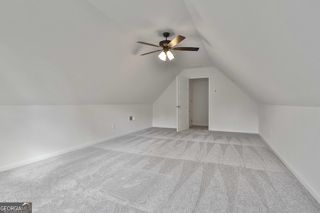 additional living space featuring light carpet, vaulted ceiling, and ceiling fan