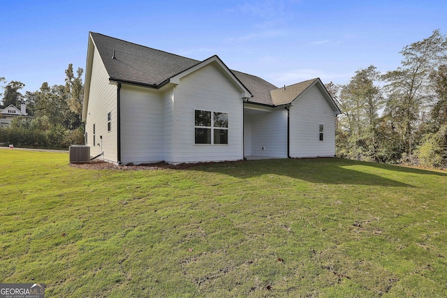 exterior space featuring central AC unit and a lawn