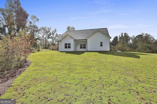 rear view of house with a lawn