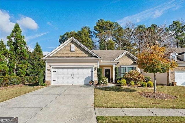 view of front of property with a garage and a front yard