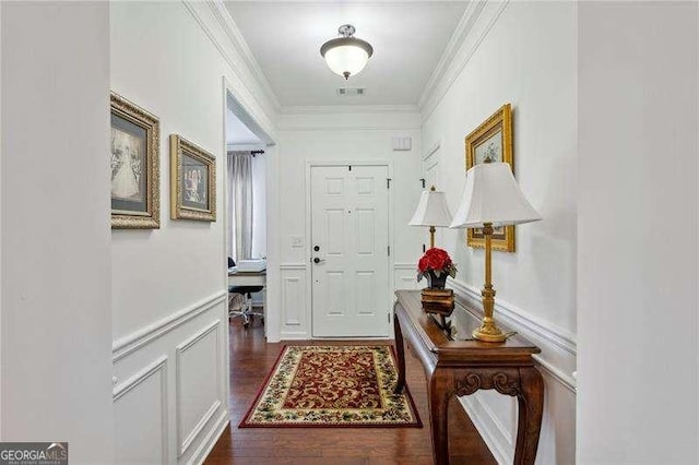 entryway with crown molding and dark hardwood / wood-style floors