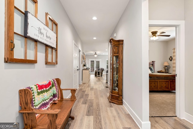 corridor with light hardwood / wood-style flooring