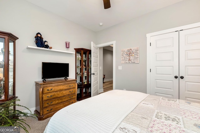 carpeted bedroom featuring a closet and ceiling fan