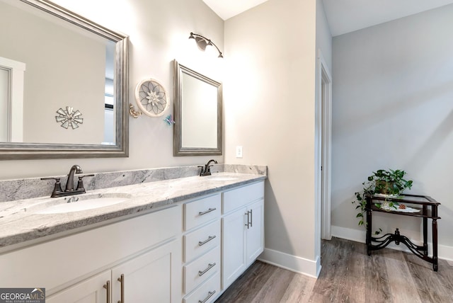 bathroom featuring vanity and hardwood / wood-style flooring