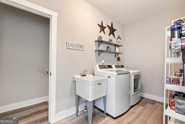 laundry room featuring hardwood / wood-style floors and washer and clothes dryer