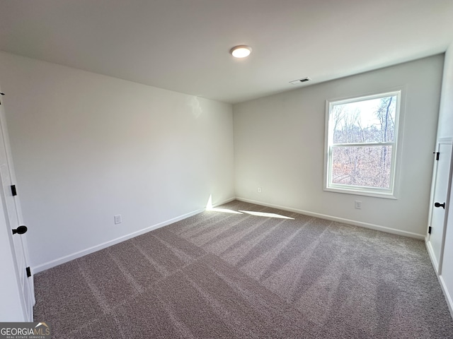 unfurnished room featuring carpet flooring