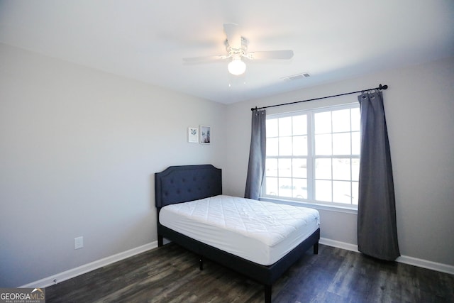 bedroom with dark wood-type flooring and ceiling fan