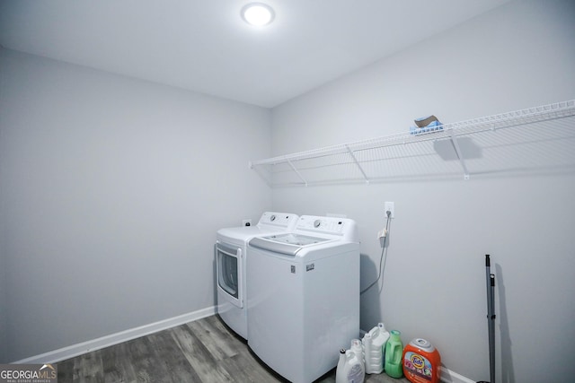 laundry room with hardwood / wood-style floors and washer and clothes dryer