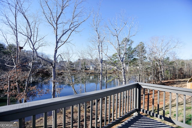 wooden terrace featuring a water view