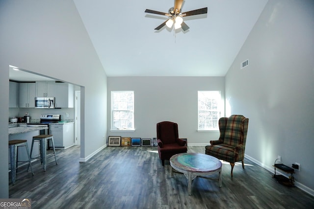 living area with dark hardwood / wood-style flooring, high vaulted ceiling, and ceiling fan