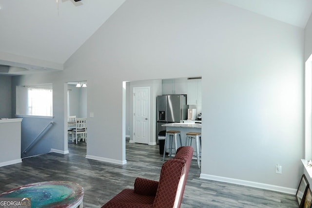 living room with ceiling fan, dark hardwood / wood-style floors, and high vaulted ceiling