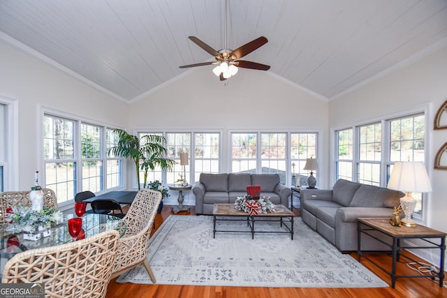 sunroom / solarium with wood ceiling, ceiling fan, and vaulted ceiling