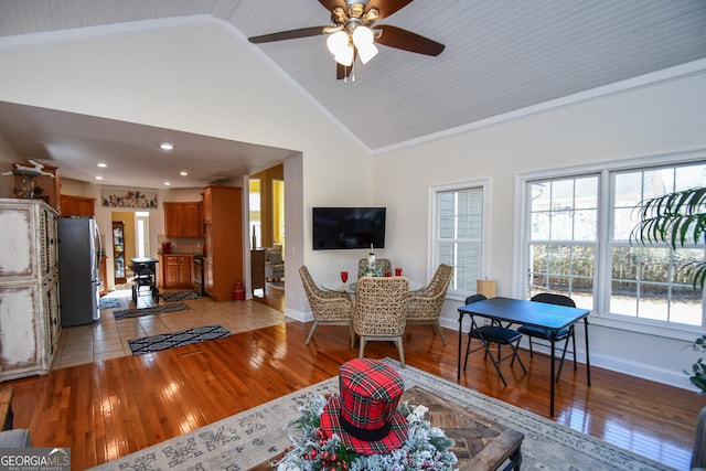 living room featuring crown molding, high vaulted ceiling, and light wood-type flooring