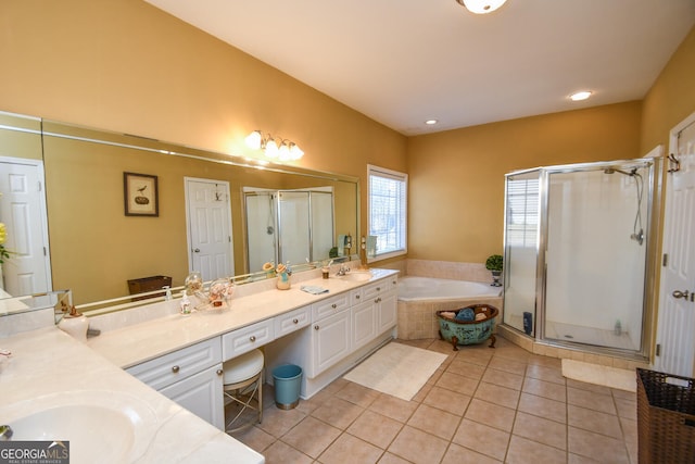 bathroom with tile patterned flooring, vanity, and shower with separate bathtub