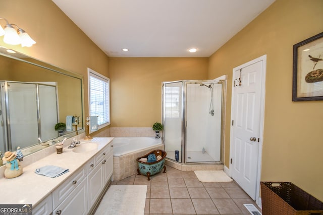 bathroom with tile patterned flooring, vanity, and independent shower and bath