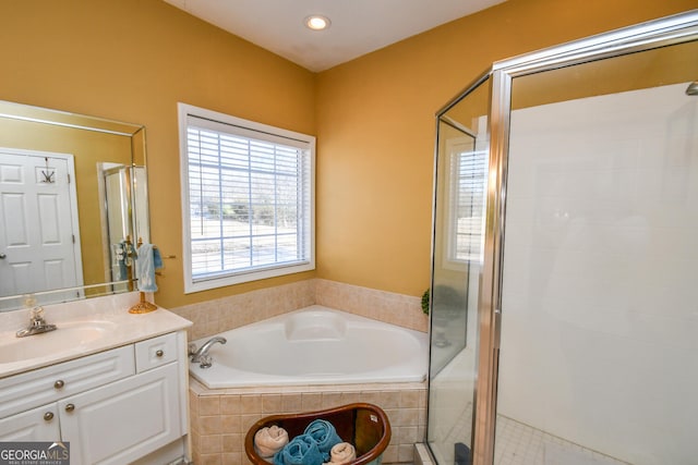 bathroom featuring vanity and plus walk in shower