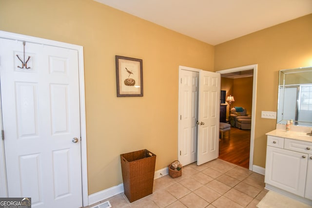 bathroom with tile patterned flooring and vanity